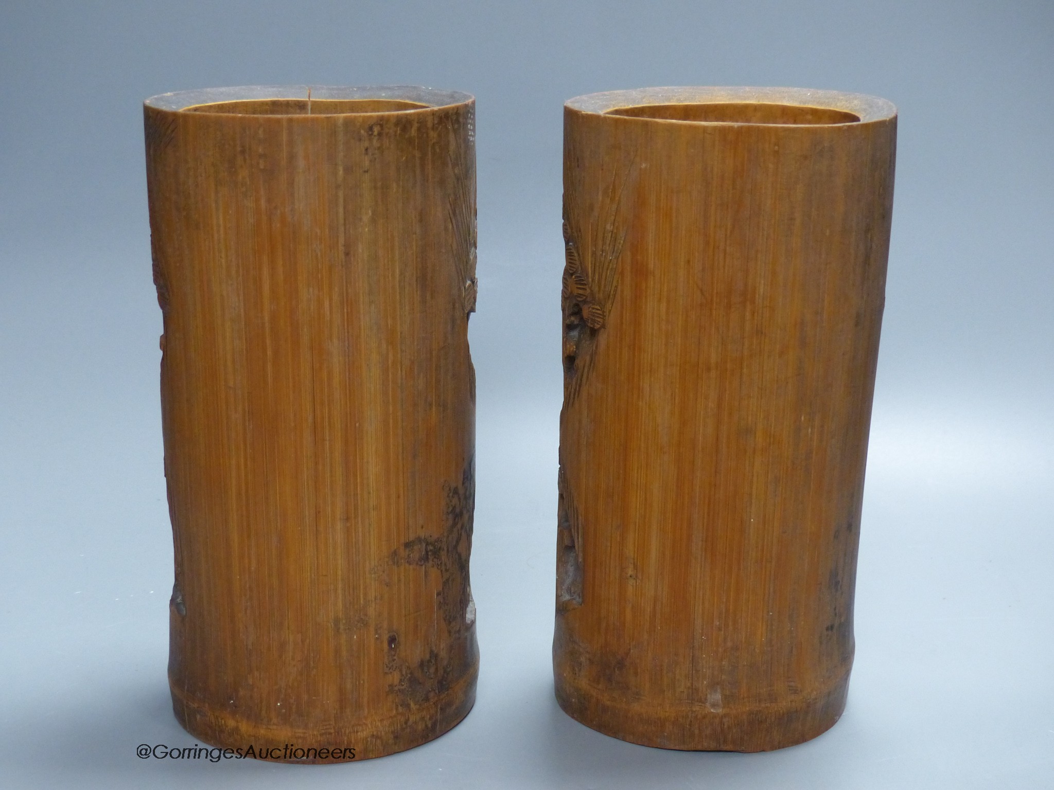 A pair of Chinese bamboo brush pots, carved with figures, signed to bases, height 21.5cm